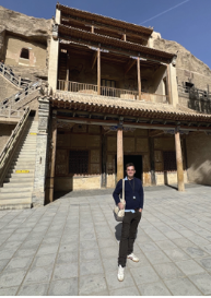 Pickett outside the famous manuscripts cave at Mogao Grottoes in Dunhuang, Gansu province 